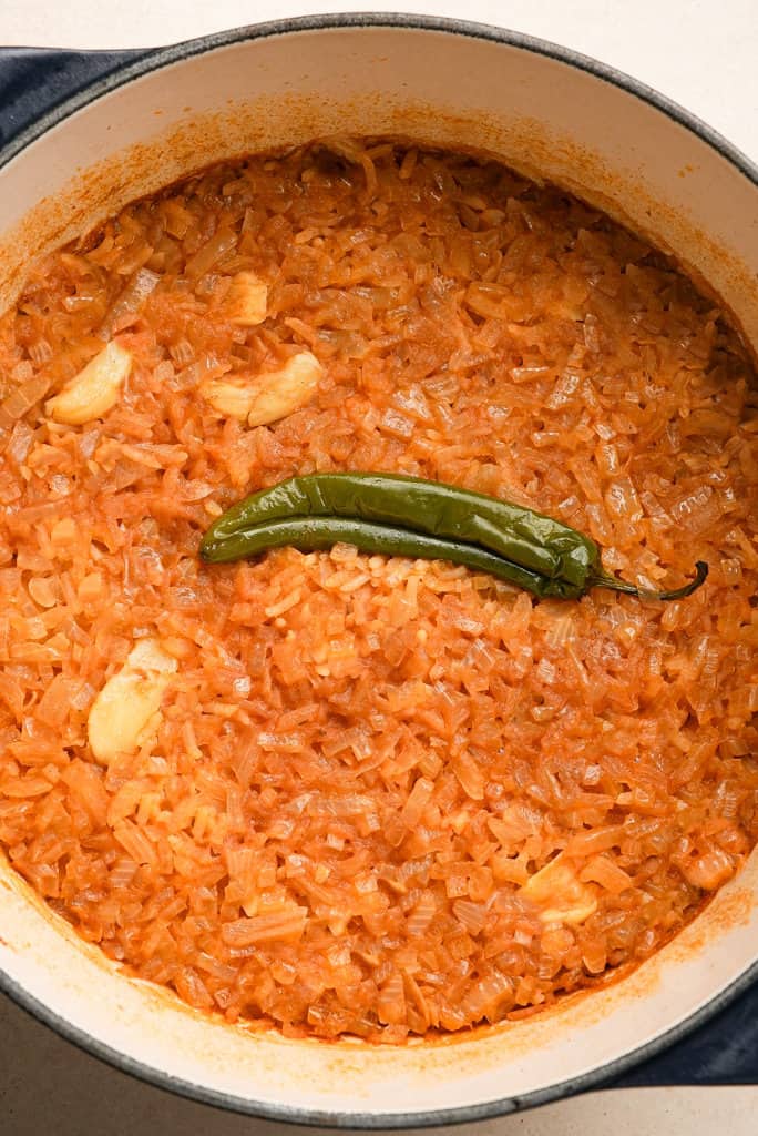 Mexican rice in a pot with a serrano pepper