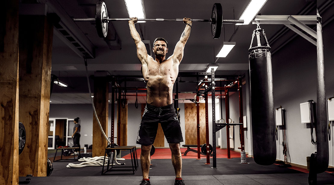 Fit Man performing a barbell snatch exercise as part of the 8 week snatch starters program
